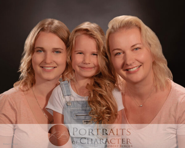 Cinematic family portrait photography in houston at Innovative Images Photography by Robert Berger. Mom photographed with two daughters at the houston tx professional photography studio.
